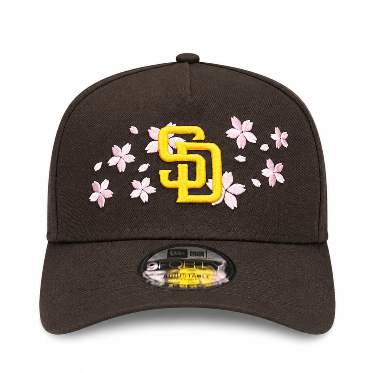 Brown cap with yellow logo and pink floral design on a white background
