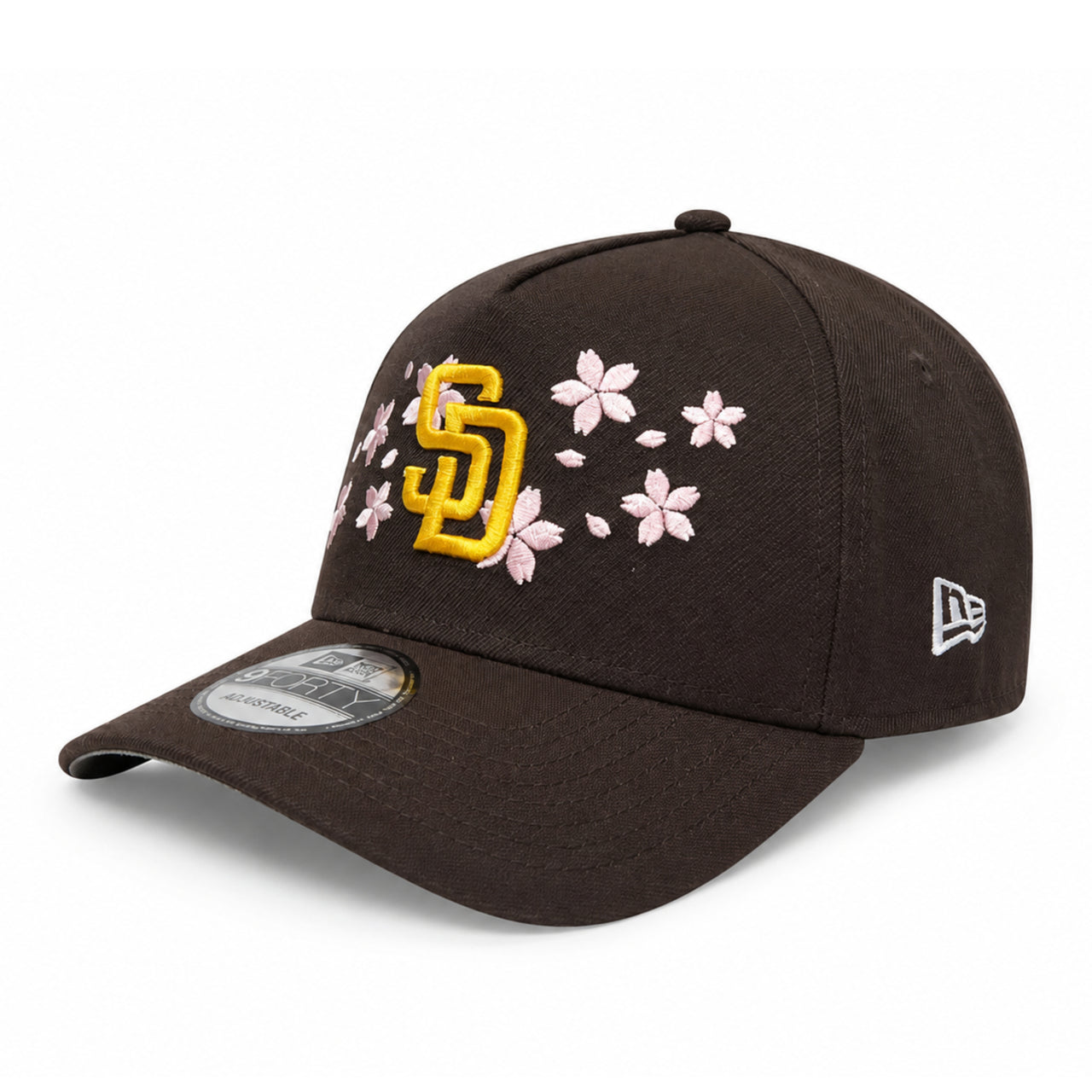 Black cap with yellow logo and pink floral designs on a white background