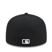 A black baseball cap with a white MLB logo patch on the front, photographed against a clean white background.