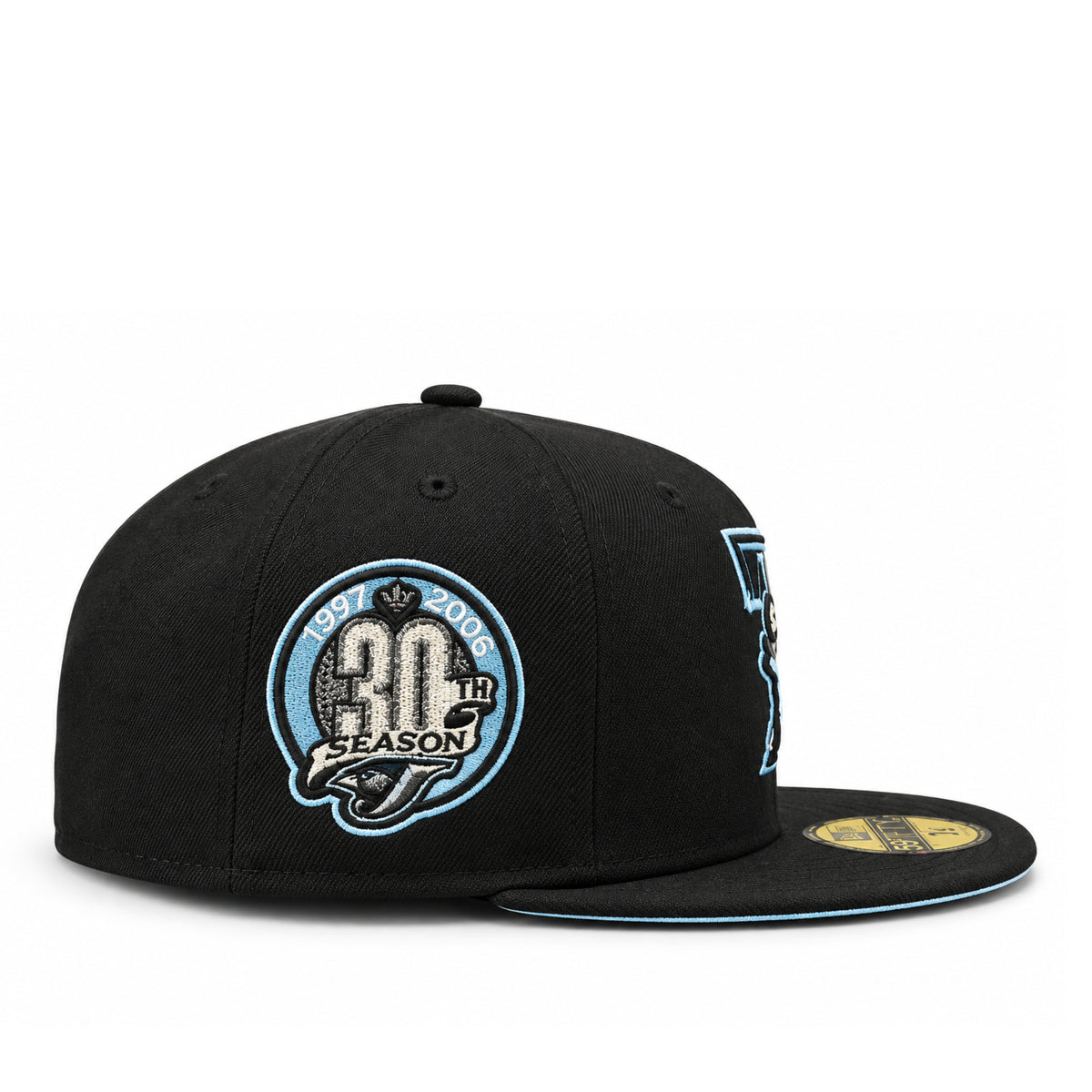 Side view of Toronto Blue Jays New Era black fitted cap showing the sky blue 30th Season embroidered anniversary patch