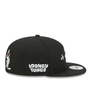 Black cap with 'Looney Tunes' logo on a white background