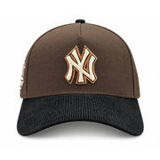 Front view of New York Yankees 9FORTY A-Frame brown snapback with raised cream NY embroidery, copper outline and black corduroy visor