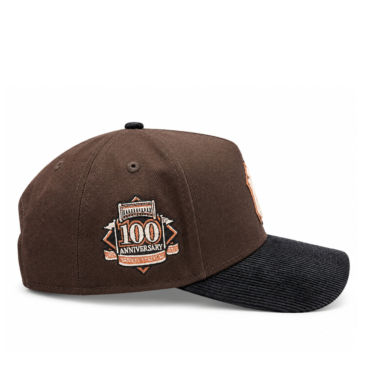 Side profile of New Era Yankees brown 9FORTY A-Frame snapback showing the 100th Anniversary embroidered patch and black corduroy curved brim