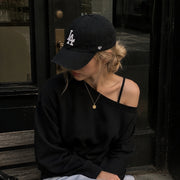 Woman wearing ’47 Brand Los Angeles Dodgers black Clean Up adjustable hat outdoors