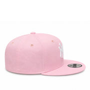 side view of  Youth New York Yankees Pink 9FIFTY Snapback Cap with white embroidered NY logo and flat visor.